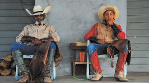 NEXT GENERATION - Chester Stidham relaxes with his son Dalton "Cooter" Stidham on the back porch at his nephew's ranch house in Paradise. Messenger photo by Joe Duty