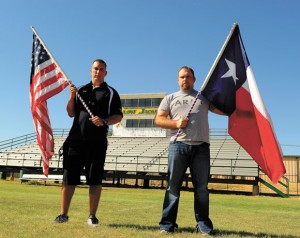 LINKS TO TRADITION - Brothers Dakota and Cisco Roberts display the flags the Boyd football team brings onto the field before each game. Cisco gave the flags, which flew in Iraq and Kuwait in 2003, to the football program. Messenger photo by Joe Duty