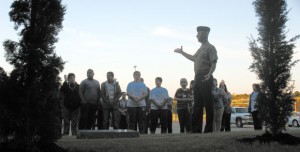 DEDICATION - Master Gunnery Sgt., and teacher at Leonard Middle School in Fort Worth, Jon McCracken addresses students and staff at Monday's dedication of Decatur High School's memorial to the victims of the Sept. 11, 2001, terrorist attacks. The two trees represent the twin towers. Messenger photo by Brian Knox