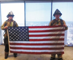 IN MEMORIAM - Representing the Decatur Fire Department, Cameron Burk, left, and Brandon McGar hold up a flag on top of the Renaissance Tower in Dallas. The pair climbed 110 flights of stairs Sunday morning in the 9/11 Dallas Stair Climb. It was a tribute to the 343 members of the New York Fire Department that died while rushing into the World Trade Center towers to save those trapped in the upper levels. Submitted photo