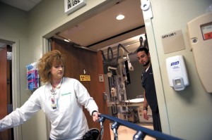 CATH LAB - Lacretia Miles, a nurse in the cardiac catheterization lab at Wise Regional Health System, pulls a gurney carrying a patient into the cath lab at the Decatur hospital as cardiovascular technologist Damien Morales CVT awaits their arrival. Messenger photo by Joe Duty