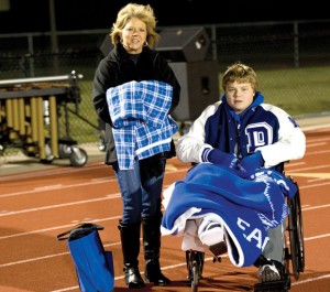 BACK ON TWO FEET — Tyler Story spent the final part of last season watching his teammates from a wheelchair with his mother, Teena, by him. Messenger photo by Joe Duty