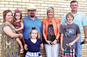 HOMETOWN HEROES - Paradise school nurse Tammy Pewitt (second from right) and Paradise seventh grader Martin Crawford (front row, right) and his dad, Ben (back row, right), were recognized for saving 3-year-old Lana Tittor who fell into a swimming pool during a Memorial Day barbecue. They are pictured with the Tittor family - mother Melanie, Lana, father Michael and sister Emma, 6. Messenger photo by Erika Pedroza