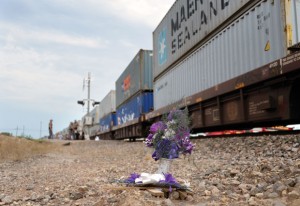 LIGHTNING STRIKES TWICE - Flowers and a cross mark the spot where Frances Cleburn, 57, of North Richland Hills, stepped in front of a train in Alvord last July. On Saturday, Marcus Silletti, 14, of Alvord, was struck and killed by a train at the same spot while walking on the tracks wearing headphones. Messenger photo by Joe Duty