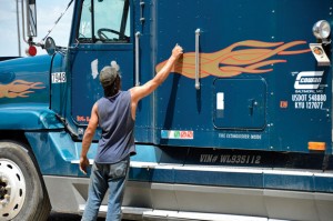 7:30 A.M. - Bud Beavers wakes a truck driver from his slumber to work on his truck. Messenger photo by Joe Duty