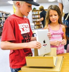 GETTING CONNECTED - Bridgeport Middle School student Tallan Miller unpacks a new iPad Thursday morning. The iPads were distributed to students for use at home and school. Messenger photo by Joe Duty