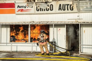 LOST PART OF CITY - Firefighter sprays water on the fire that destroyed Chico Auto Parts Saturday morning. Nearly 40 firefighters battled the blaze. Messenger photo by Joe Duty