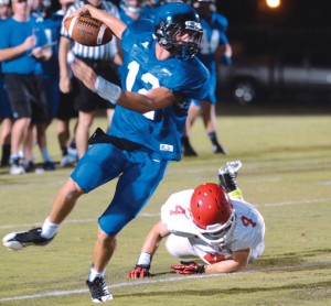 SLIPPING AWAY - Decatur quarterback Grayson Muehlstein runs away from a Mineral Wells tackler during the Eagles' scrimmage Friday. Messenger photo by Mack Thweatt