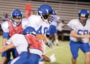 SLIPPING BY - Running back Max Junkert gives at least two defenders the slip as he racks up yards during the Eagles' scrimmage Saturday. Messenger photo by Jimmy Alford