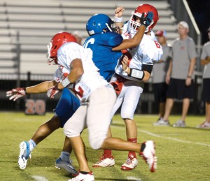 TAKE THAT - Decatur's Oscar Deleija pressures the quarterback during Decatur's scrimmage against Mineral Wells Friday. Messenger photo by Mack Thweatt