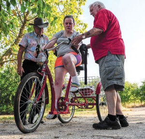 UNSTOPPABLE - Charlie Young and Bill Silver, members of AMBUCS service organization, Thursday present Jessica McClure of Greenwood with an AmTryke, a modified tricycle that accommodates riders of all ages, sizes and physical limitations. McClure has cerebral palsy with dystonia. Messenger photo by Joe Duty