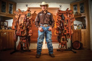 BIG WINNING - Brett Stuart of Bridgeport has won numerous saddles having rodeoed since he was 3, but perhaps the most coveted is the one he earned for winning the National High School Rodeo Association Junior Division title in team roping in July. Messenger photo by Joe Duty