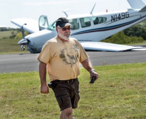 CRASH LANDING - Robin Lawson of North Richland Hills walks away unharmed from the Beechcraft Bonanza he was piloting Sunday morning. The aircraft belly landed on the Decatur Municipal Airport runway after Lawson "Hit the wrong button." Messenger photo by Joe Duty