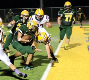 CROSSING THE LINE - Boyd's Fino Cardona pushes his way into the end zone, scoring against the Wildcats. Messenger photo by Mack Thweatt