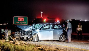 FATALITY - DPS Trooper Greg Reyero inspects the vehicle involved in a fatal accident just north of Alvord early Monday morning. Messenger photo by Joe Duty