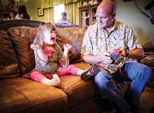 FATHER'S LOVE - Five-year-old Katie Vance of Alvord communicates with her dad, Kenson III, with hand and facial expressions. Kenson used to work in the airline industry but took a job closer to home as director of operations for Alvord ISD to be able to better care for Katie, who has Down syndrome and kicked leukemia this summer. Messenger photo by Joe Duty