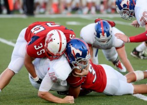 GOING DOWN - Northwest's Cody Duffey helps make a tackle against Grapvine. Messenger photo by Mack Thweatt
