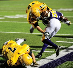 GOING DOWN - Decatur's Michael Partin heads down to join Cole Meador on the ground after bowling over a Sanger defender. Messenger photo by Joe Duty