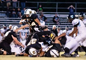 OVER THE TOP - Chico's Dylan Hightower leaps over fellow players and foes alike as he pushes forward. Messenger photo by Jimmy Alford