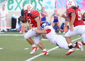 PICK UP - Northwest defensive lineman Joe Gonzales returns a fumble for a 35-yard touchdown in the Texans' 28-7 win over the Grapevine Mustangs. Messenger photo by Mack Thweatt