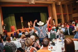PROUD HUSBAND - James Redwine cheers on his wife, Nellie, as she makes her way across the stage in the Ms. Senior Wise pageant. She was escorted by her son, Chico Fire Chief James "Poncho" Redwine. Messenger photo by Joe Duty