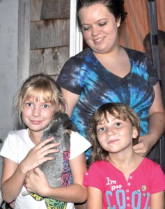 ROSY RESCUE - A-lisa Kendrick, 9, holds Rosy close minutes after the puppy was rescued from a well by Alvord firefighters. Sisters Kaylee Kendrick, 6, and Jennifer Dean were also grateful Rosy was rescued. Messenger photo by Brandon Evans