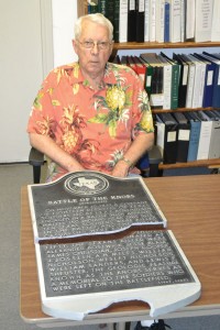 SHATTERED PLAQUE - Wise County Historical Museum volunteer Jack Gainer shows the Battle of the Knobs historical marker that was accidentally shattered by an Oncor worker northwest of Decatur last Thursday. Messenger photo by Bob Buckel