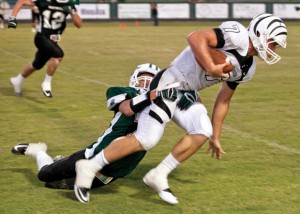 SLIPPING AWAY - Panther Corner back Chris Lowery loses his grip on a Grandview Zebra as he is dragged across the turf. Messenger photo by Jimmy Alford