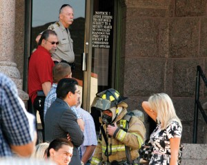TRIAL BY FIRE - Jurors, defendants and lawyers spilled onto the lawn of the courthouse Wednesday morning after someone tossed a lit cigarette into a trash can. Messenger photo by Jimmy Alford