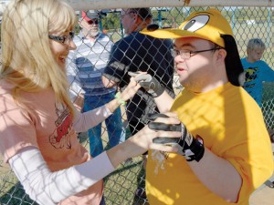 BLESSED MOMENTS - Wise County Special Needs Baseball volunteer Lori Jones of Rhome and her buddy, Josh Dodd, pump up before a game Saturday.  Messenger photo by Joe Duty