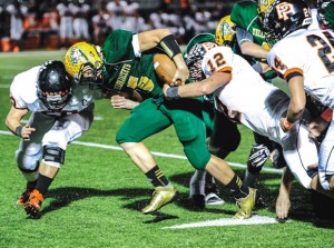 CHURNING AHEAD - Boyd's Blake McDonald fights through Pilot Point defenders Friday. Messenger photo by Joe Duty
