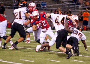 FINDING A HOLE - Northwest's Dakota Chavis looks for running room against Haltom. Messenger photo by Jimmy Alford