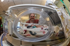 PROUD DAD - Christopher McDaniel of Rhome watches his son, Asher Lane, as he sleeps. Asher and his twin, Levi, were born at 32 weeks and are "doing wonderful." Messenger photo by Joe Duty