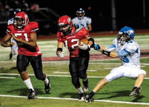 PULLING HARD - Decatur's Jared Durdon tries to take down a Gainesville runner during the Eagles' 42-21 loss Friday night. Messenger photo by Joe Duty