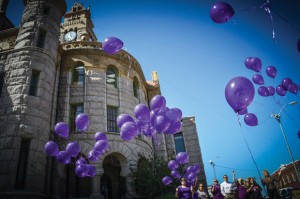 SIMPLE REMINDER - The Wise Hope Shelter and Crisis Center released purple balloons from the lawn of the county courthouse in Decatur Monday. The event marked the start of Domestic Violence Awareness Month. Messenger photo by Joe Duty