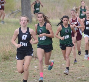 STRONG FINISH - Alvord's Savannah Williams and Paradise's Bailey Sides and Ashley Sparks make their way to toward the finish line during the district cross-country meet Monday. Both teams advanced to the regional meet. Messenger photo by Mack Thweatt