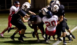 TEAM EFORT - Dragons gang tackle a Dallas A+ runner Friday night in Chico's 71-13 victory. Messenger photo by Jimmy Alford