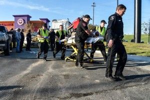 TUESDAY WRECK - Medics load the driver of an 18-wheeler into an ambulance to be transported to Wise Regional Health System, from where he was flown to Texas Health Fort Worth Hospital. Messenger photo by Joe Duty