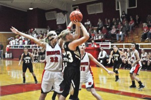 AND SHE SHOOTS - Alvord's Ariel Rogers lins up a two-point shot with two Munster players moving up close to block. Messenger photo by Clay Corbett