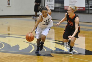BREAKING AWAY - Decatur's Jasmyne Tate dribbles past an Aledo defender Tuesday. The Lady Eagles dropped their first game of the season, 53-39. Messenger photo by Clay Corbett