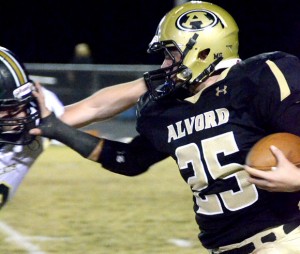 FACE-TO-FACE - Alvord's Joe Randall gives as good as he gets to extend a running play. Messenger photo by Mack Thweatt