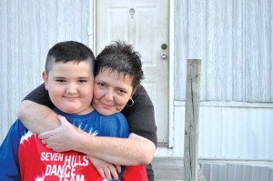 LIFESAVING ACTION - Milissa Moore of Newark hugs her son, Grayson. The 11-year-old recently helped save his mom's life when she went into a series of seizures outside their home. Messenger photo by Brandon Evans