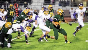 MAKING TRACKS - Boyd's Fino Cardona slips past a host of Farmers on his way downfield. Cardona had 27 carries for 160 yards to lead the Yellowjackets in rushing Friday night. Messenger photo by Joe Duty
