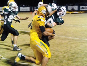 TAKE THAT - Boyd's Fino Cardona uses a stiff arm to ward off Panther Cody Carmichael in Friday's 21-0 Yellowjacket victory. Messenger photo by Mack Thweatt