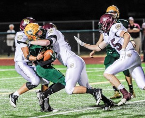 TOUGH NIGHT - Boyd's Blake McDonald is brought down by two Whitesboro Bearcats Friday. With the loss the Yellowjackets finish third in district play. Messenger photo by Joe Duty