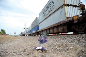 ALVORD TRAGEDY - Flowers and a cross mark the spot where a North Richland Hills woman stepped in front of a train in Alvord in July 2011. Almost exactly one year later, Marcus Silletti, 14, of Alvord, was struck and killed by a train at the same spot while walking on the tracks wearing headphones. Messenger photo by Joe Duty