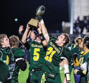 BIG WIN - Boyd's Blake McDonald and Adrian Nelson raise the trophy after the Yellowjackets' first round playoff win against Farmersville. Messenger photo by Joe Duty