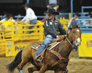 BREAKING AWAY - Decatur cowboy Trevor Brazile, 36, looks to capture a world championship in team roping tonight with partner Patrick Smith, of Lipan. If they win, it will be Brazile's 18th gold buckle, tying him for most ever with Guy Allen. Brazile already won his 10th all-around world title after only five rounds at National Finals Rodeo. Photo by Kirt Steinke/Western and Rodeo Images