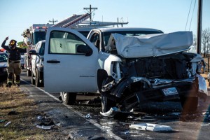 CRUSHED - A white pickup driven by Peter Davis, 26, was rammed by a van and pushed into the back of the stopped school bus. Messenger photo by Joe Duty