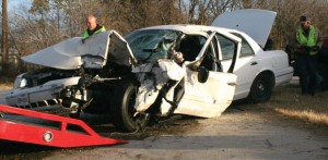 DRIVER EXTRICATED - A Crown Victoria is about to be loaded onto a wrecker after a Dec. 22 accident on Farm Road 718. Tyler Huffman, 30, of Newark had to be  extricated from the car. Messenger photo by Kristen Tribe